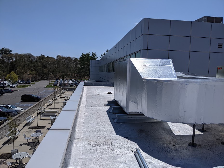 Rooftop mechanical equipment and insulated piping on a Conte Insulation project site