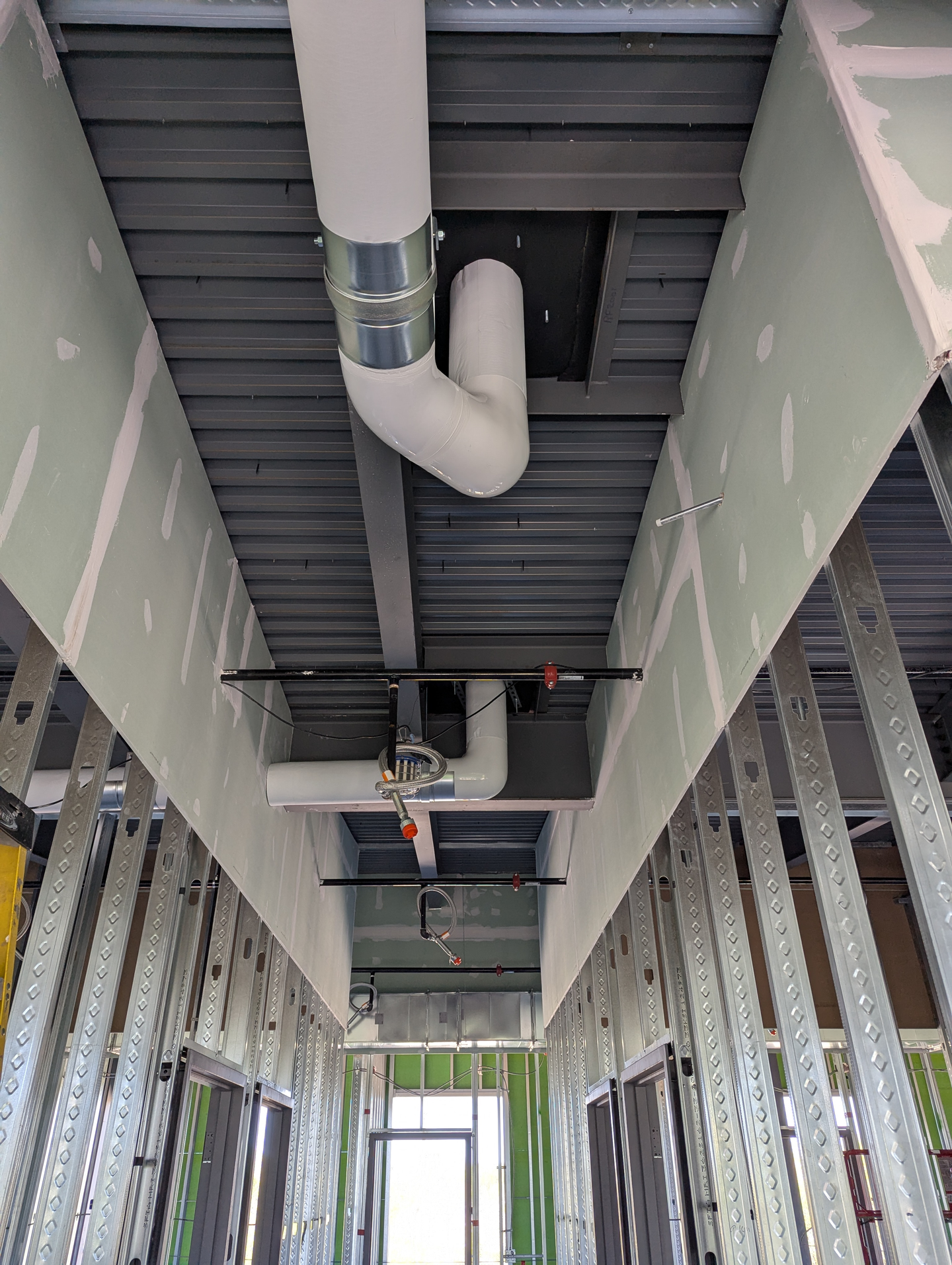 Storm drain line insulation preventing condensation and noise - Wisconsin commercial building